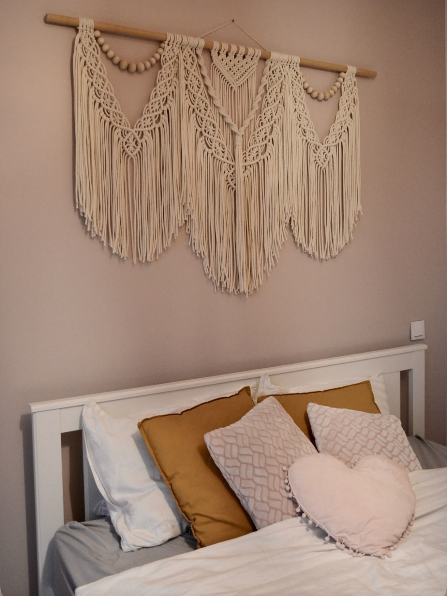 Wall piece above a bedroom headboard